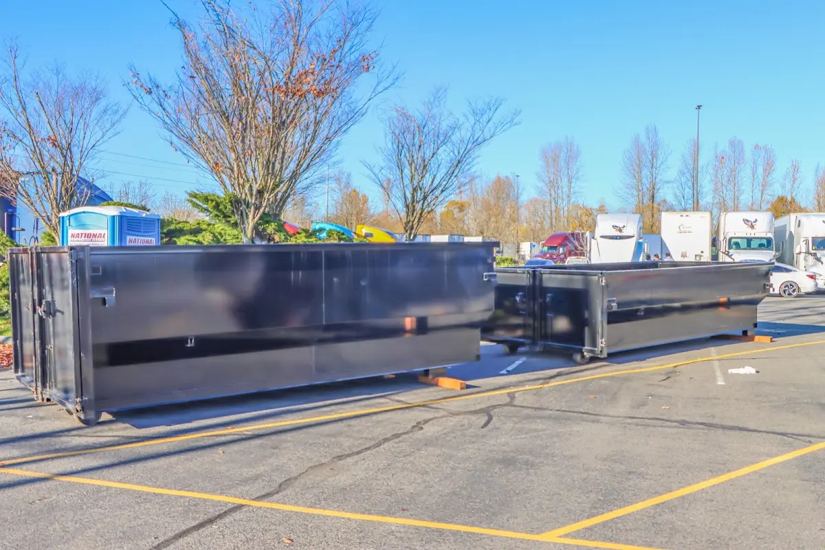 Professional dumpster rental service with roll-off container on residential driveway in Hazel Park